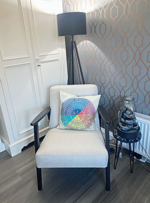 Calm, neutrally decorated counselling room with comfortable seating